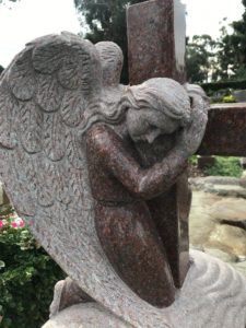Lone angel hugging cross